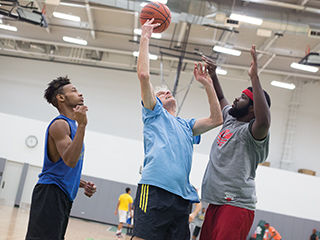 Vice President of Student Affairs Mark Kelly throws up a hook shot during the Nov. 13 3-on-3 Renegades basketball tournament at the Goodman Center.