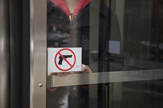 Over winter break the college placed signs on all campus building doors indicating that guns are prohibited on the colleges campus. The college is complying with the new Illinois Firearm Concealed Carry Act.