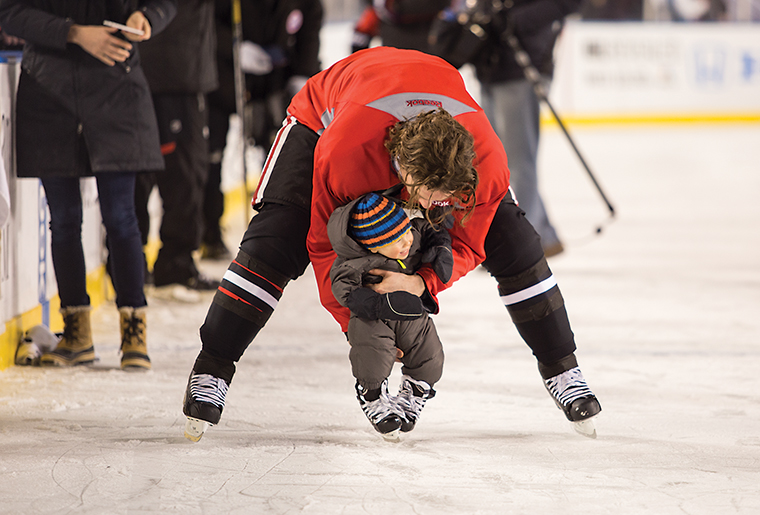 Blackhawk Defenseman Duncan Keith takes son Colton on a skate around the ice during Blackhawks family skate before the game.