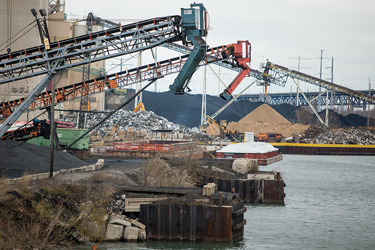 KCBX Terminals Co. stores stockpiles of petroleum coke on the banks of the Calumet River on the Southeast Side. KCBX must fully enclose its stockpiles within two years under regulation imposed March 13 by Mayor Rahm Emanuel.