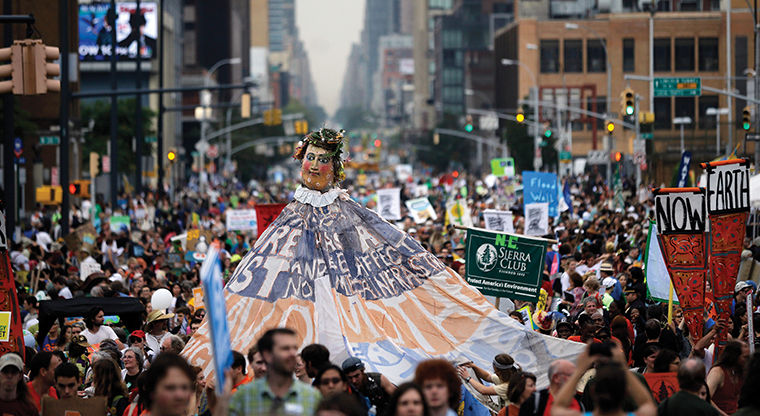 People fill the street during the Peoples Climate March, Sunday, Sept. 21, 2014, in New York. Tens of thousands of activists walked through Manhattan on Sunday, warning that climate change is destroying the Earth — in stride with demonstrators around the world who urged policymakers to take quick action. (AP Photo/Mel Evans)