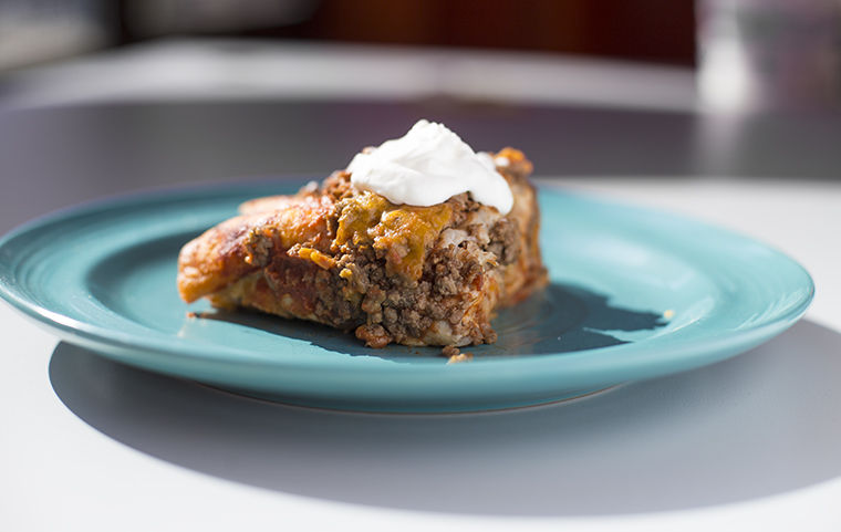 Beef+enchiladas+topped+with+sour+cream.