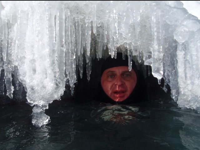 David Oliva “cooling off” under an ice floe on Lake Michigan. Oliva said he has been braving frigid waters around the world as a winter swimmer for more than 35 years.