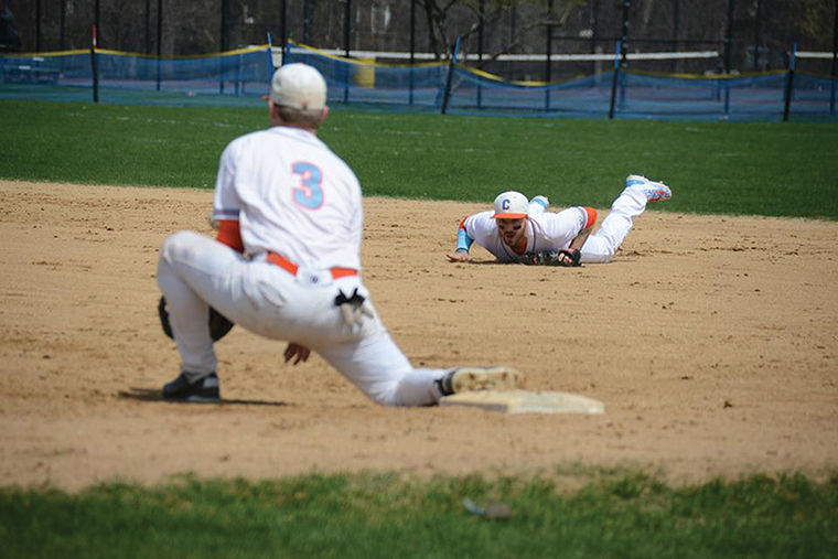 Jameson Swain makes a diving stop to second base and to get the out, tossing  the ball to first baseman Joe Walsh, in a game against DePaul University Baseball on April 18. 