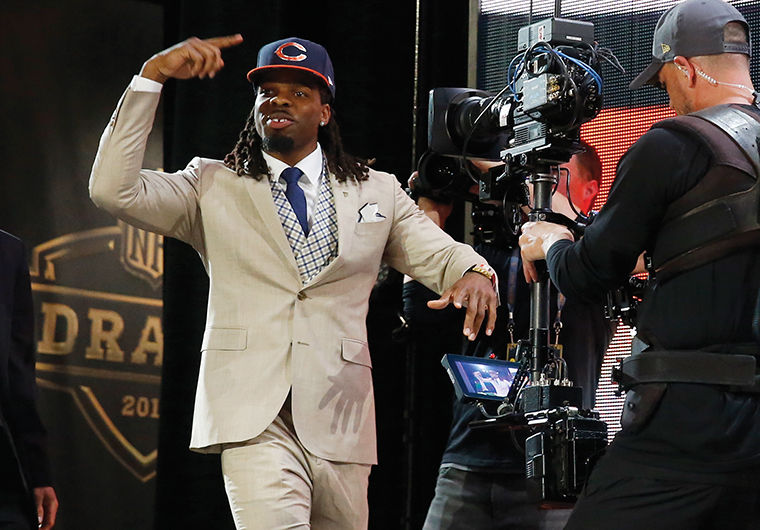 West Virginia wide receiver Kevin White celebrates after being selected by the Chicago Bears as the seventh pick in the first round of the 2015 NFL Draft, Thursday, April 30, 2015, in Chicago. (AP Photo/Charles Rex Arbogast)