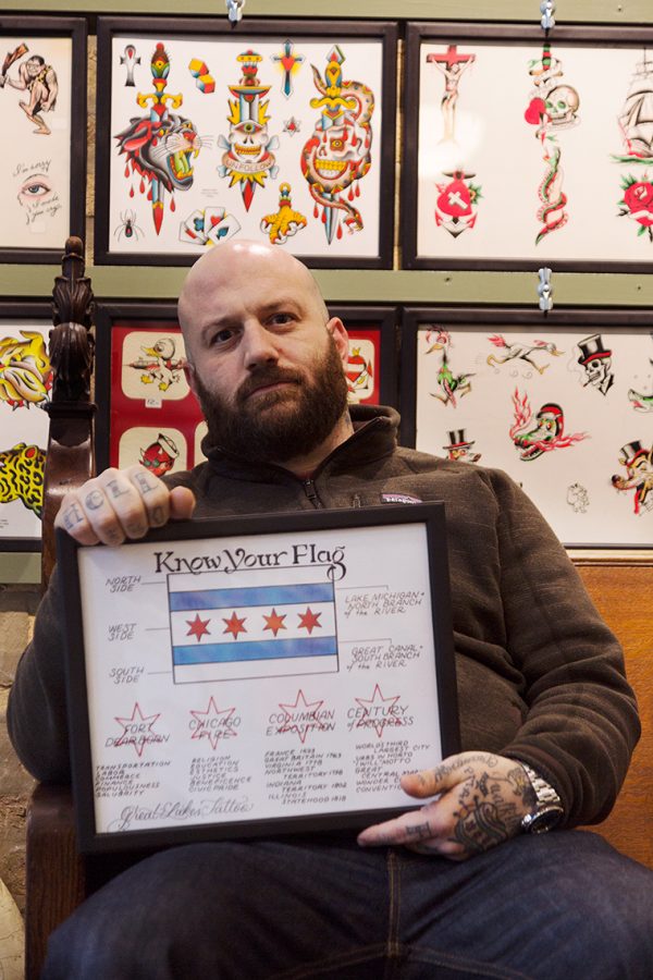 Nick Colella, owner of Great Lake Tattoo, located at 1148 W Grand Ave, is selling know your flag print to curious customers and proud Chicagoans