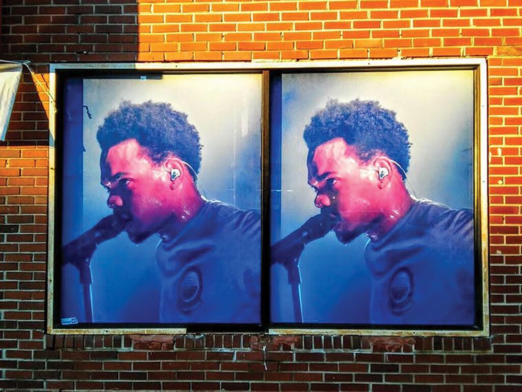 Paintings of Chance the Rapper and Common are plastered on buildings on 79th and Evans streets in the Chatham neighborhood to boost positive imaging.