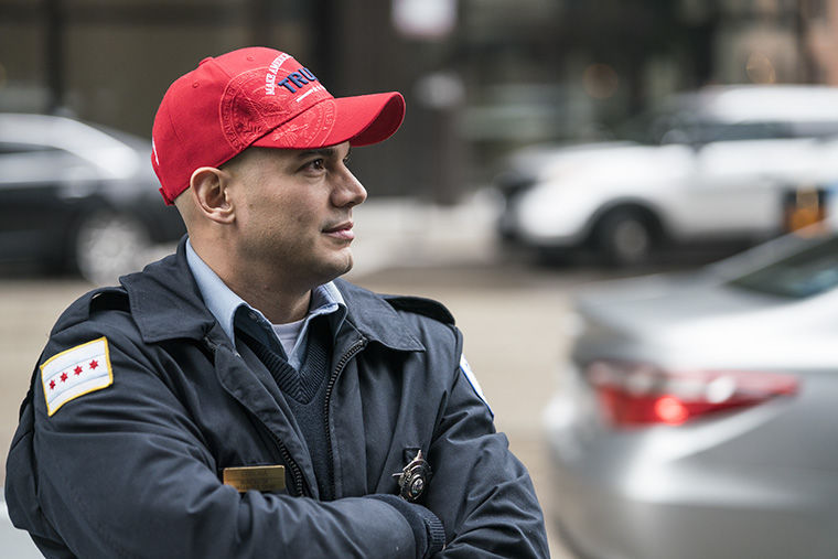 Chicago Police Officer Corona shows his support for the new President by wearing a Pro-Trump Hat before the day’s protest. Chicago citizens chanted and marched in protest of President Donald Trump’s inauguration around the city of Chicago on Jan. 20.