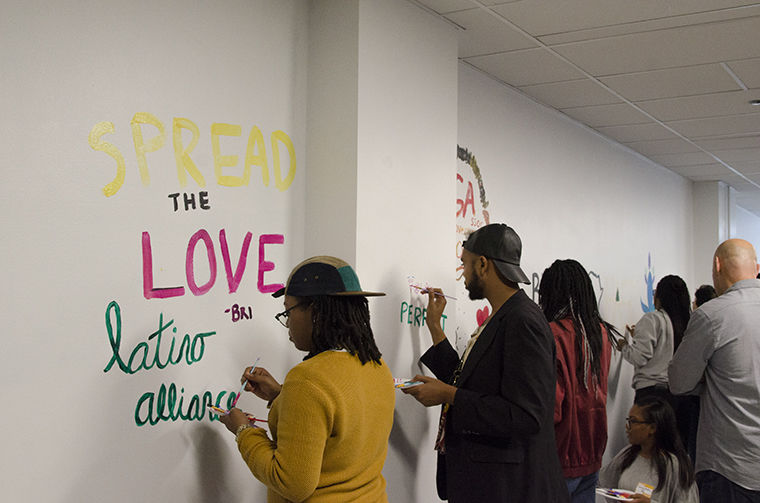 Students and student organization representatives painted messages and images on the new mural wall as a part of the offices unveiling on the fourth floor of 618 S. Michigan Ave. Sept. 7.