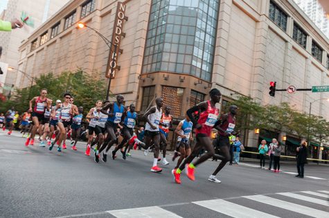 The mens elite group runs through River North at Grand and Wabash after the first mile marker during the 2017 Bank of America Chicago Marathon on Oct. 8.