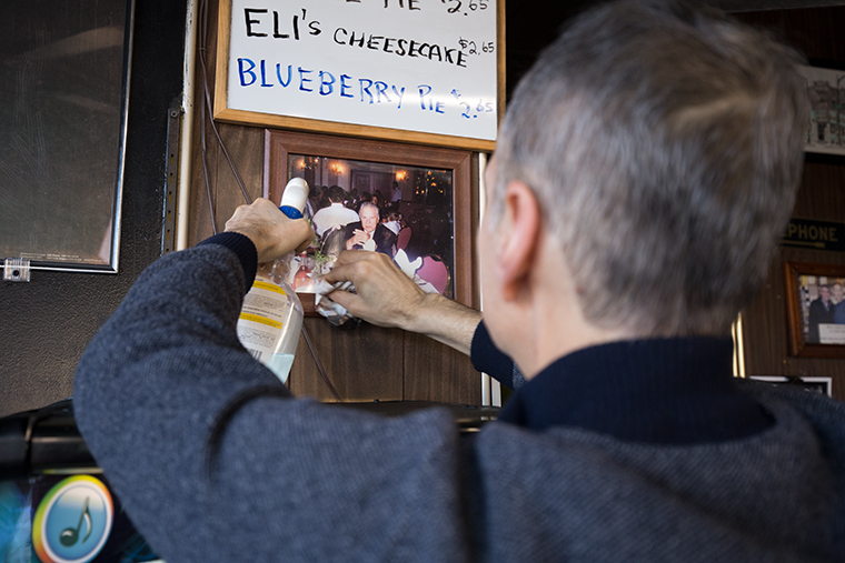 7:42 a.m. Frank hangs a photograph of his father and original owner of Jeri’s Grill, Anice, above the new jukebox. “There’s the legacy of my dad, I wouldn’t be here without him—that’s for sure,” Frank said. “He started it all.”