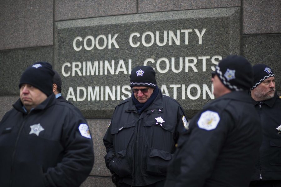 Police officers stand in front of the Leighton Criminal Courthouse where Jason Van Dyke was sentenced to 81 months in prison.