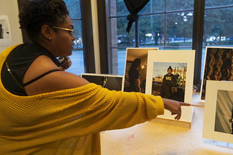 Loren Toney, 2019 photography graduate from Columbia, sets up her prints before the event starts Sept. 9. 