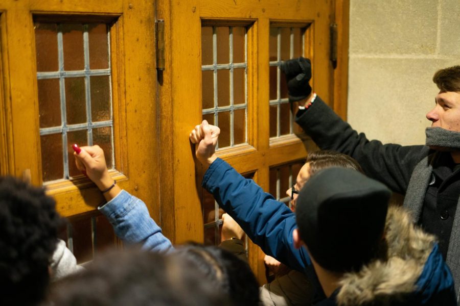 Protestors banged on the doors in order to disrupt former Attorney General Jeff Sessions remarks on Northwestern Universitys campus Tuesday, Nov. 5.