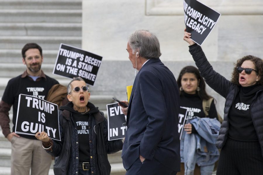 (Center) Sen. Ed Markey (D-Mass.) passes by protestors outside the U.S. Capitol in the midst of President Donald Trump's impeachment trial in the U.S. Senate.