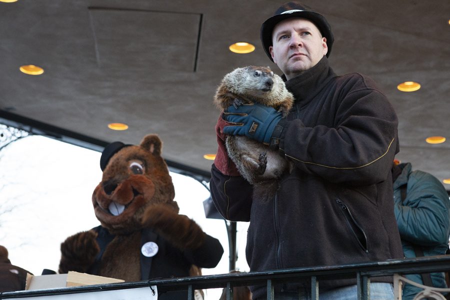 Mark Szafaran holds Woodstock Willie, who has played a part in the town's Groundhog Day celebration since the former mayor, Bill Anderson, requested a groundhog be present in 1997, the same year the groundhog costume was introduced.