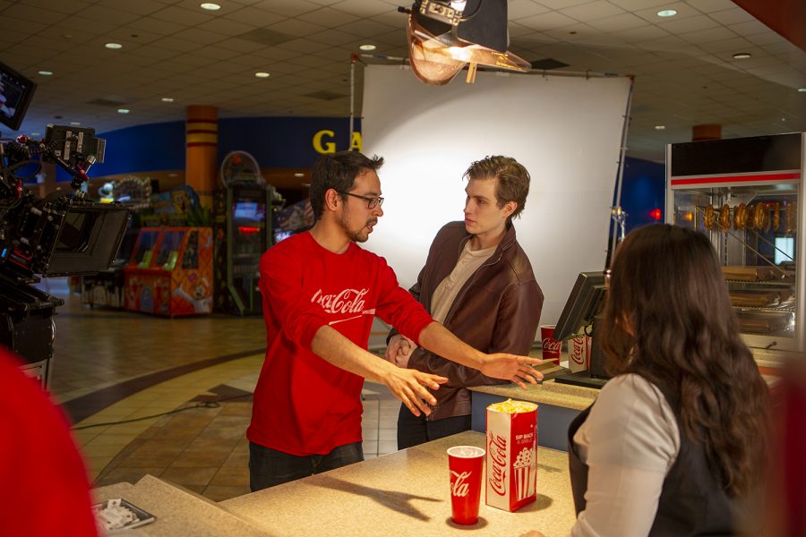 Miguel Garcia (left) gives directions to Brian Healy and Rachel Kim during the commercial shoot.