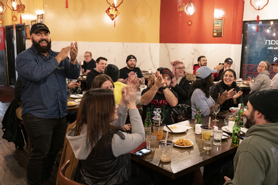 Carlos Matias leads a round of applause in Lao Sze Chuan to celebrate the restaurant bar crawl.