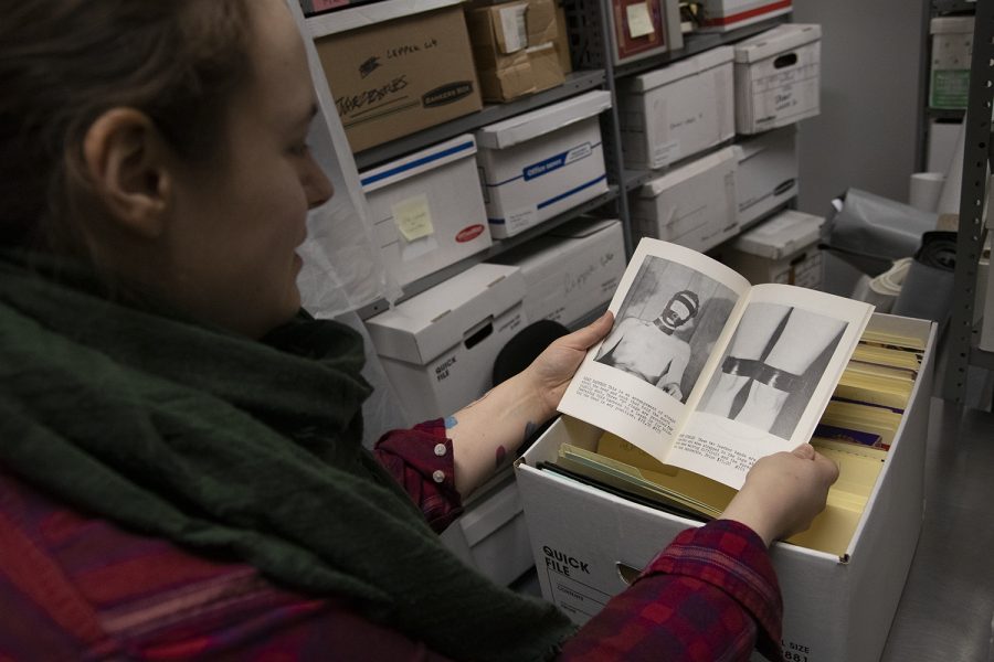 Mel Leverich, a museum archivist, reads through a BDSM mail order catalog in the archives.