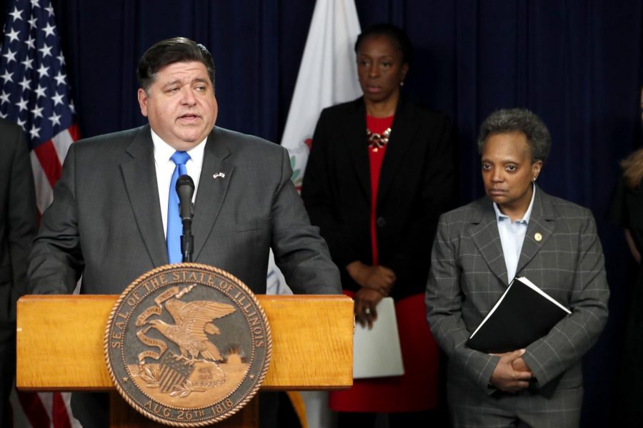 (From left) Gov. J.B. Pritzker and Chicago Mayor Lori Lightfoot announce a stay-at-home order asking Illinois residents to stay at home except for essential travel, such as to grocery stores or for medical assistance.