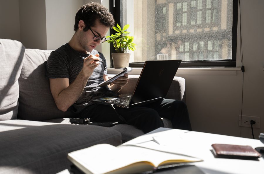 Staff Reporter Jonah Ocuto works on articles from his living room as he self-quarantines.