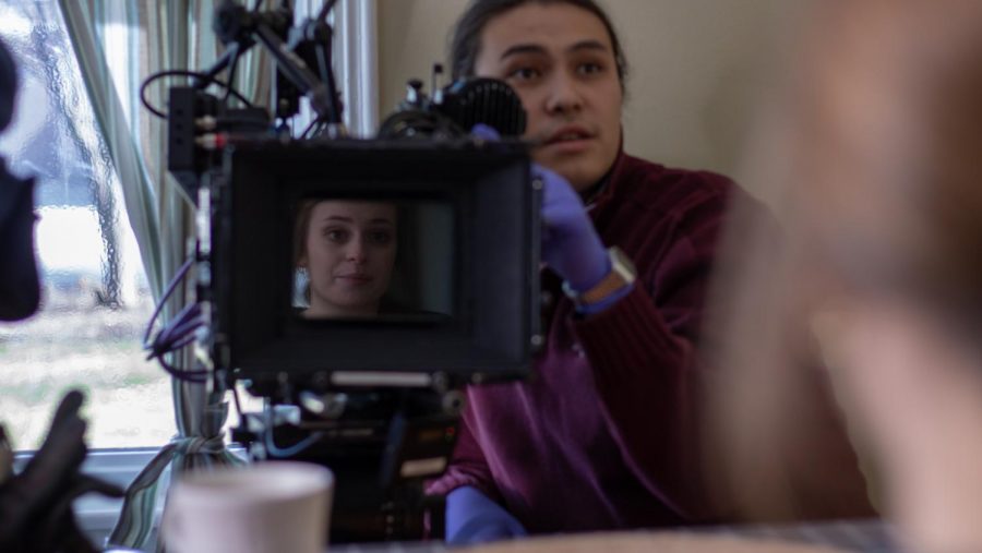 Students Lucas Miroslaw (right) and Giana Carli (center) work on the film set of a Directing 3  project. It was the only shoot to be wrapped before classes were suspended.