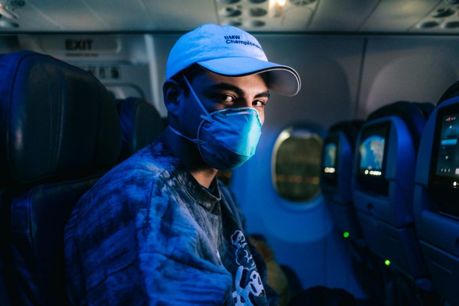 Nicolas Gil, a sophomore Ventura College philosophy major, wears a respirator during the four and a half hours flight to Los Angeles.