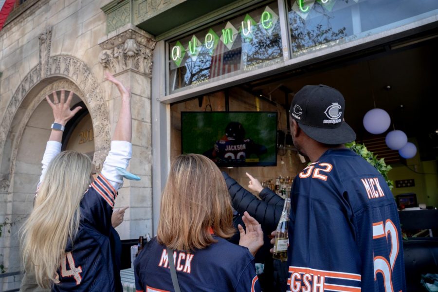 Katherine Bauer-Drozdzik (left) cheers for the Chicago Bears as they finish off the New York Giants on their last defensive play to win their home opener.