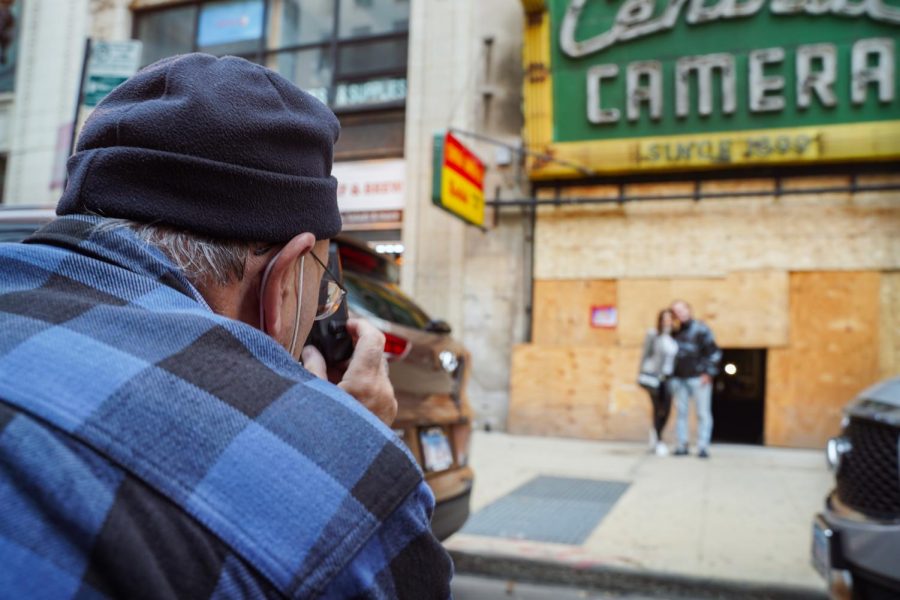 Flesch takes a photo with a disposable camera for his supporters, Armando Orozco (right) and Mariana Castellanos (left) who were visiting Chicago.