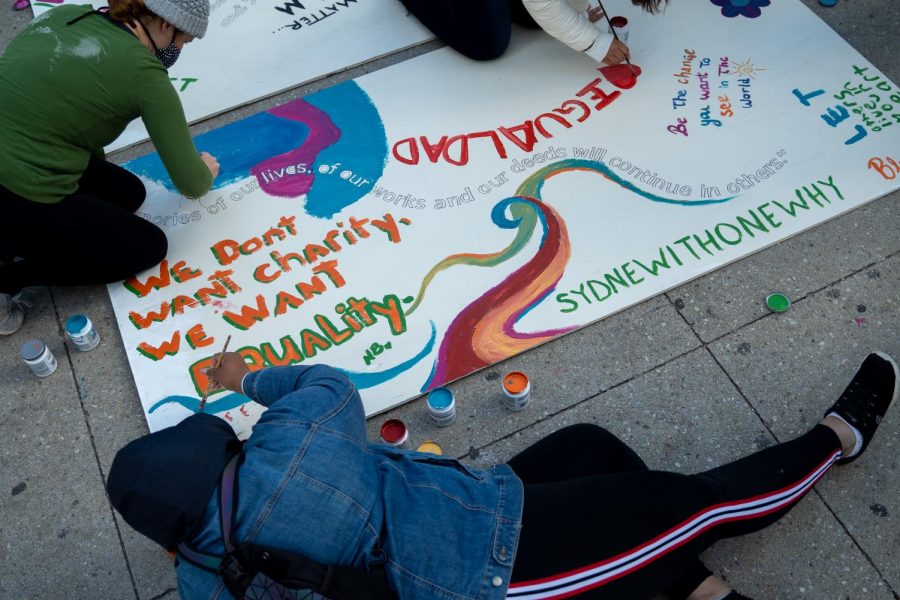 Nia Brown, a South Side Chicago resident, decides to help paint the mural after walking by Millennium Park.