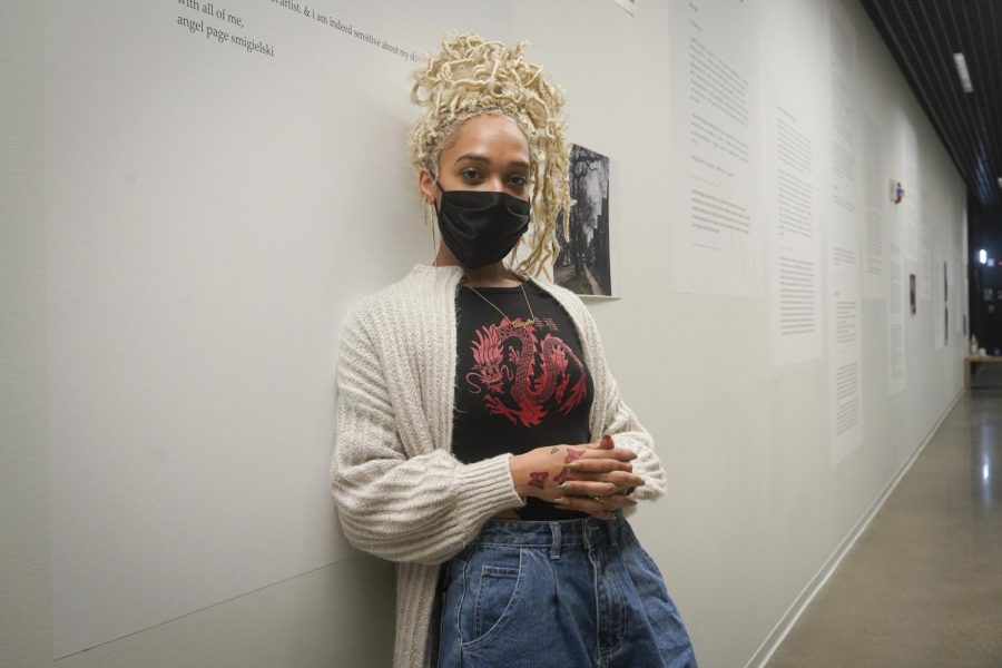 Angel Page Smigielski stands in front of their exhibit titled 70th & Throop on the fifth floor of the Student Center, 754 S. Wabash Ave, it is one of four exhibits in the Black Souls Welcome showcase