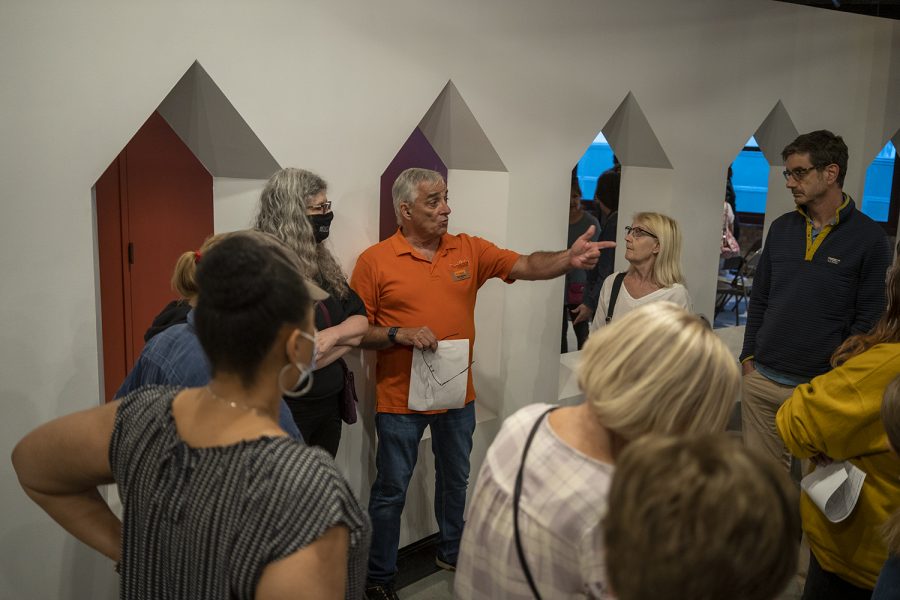 James Wales, president of the South Loop Neighbors, talks with meeting attendees in small groups about how they can help form the neighborhood watch.