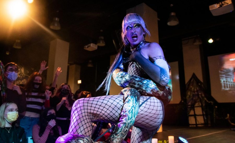 Drag Queen Abhijeet performs in front of cheering Columbia students dressed in fishnets and a fake snake.