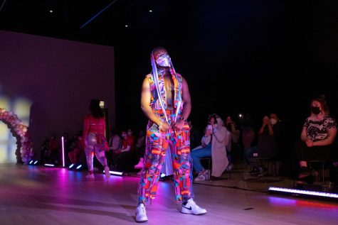 With spotlights beaming through the event space, vibrant fabrics and designs are put on display throughout the Y2K themed fashion show.