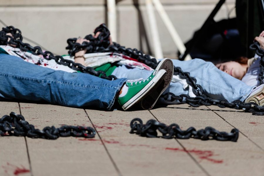 Demonstrators lie on the ground as speakers discuss the issues surrounding access to safe abortions in El Salvador and the U.S.