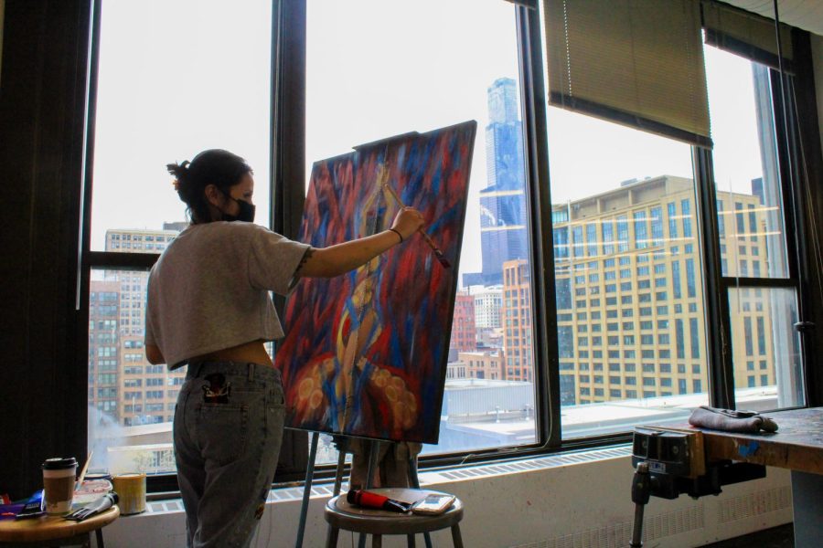 Carolina Romo often goes to the open studio on the 8th floor of Columbias 623 S. Wabash Ave. building and works on two paintings at the same time with a wide view of the city. 