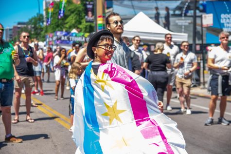 Viviana Ramirez, a Pride Fest attendee, shows off a Chicago flag designed with the pansexual pride colors. 