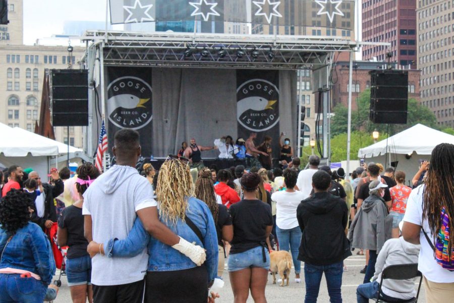 Dozens gather at one of the Taste of Chicago stages to enjoy the free live music.