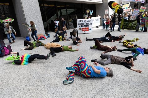 Protesters dressed as various animals lie on the ground as if they died due to the effects of climate change outside Chase Tower, 10 S. Dearborn St. 