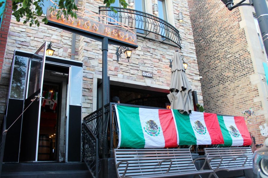 The outside of Pilsen restaurant Cantón Regio, 1510 West 18th St., is decorated with papel picado and Mexican flags in preparation for El Grito and Mexican Independence Day.