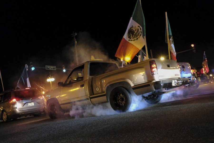 Sporting a small sombrero, a pickup truck pours smoke onto East Plaza Drive as it burns its tires on the concrete.
