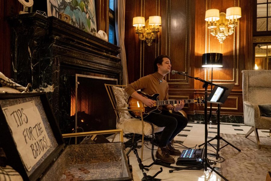 Guitar chords and soft melody float through the lobby as Joshua Trimble plays a cover of Frank Ocean's "Thinkin Bout You."