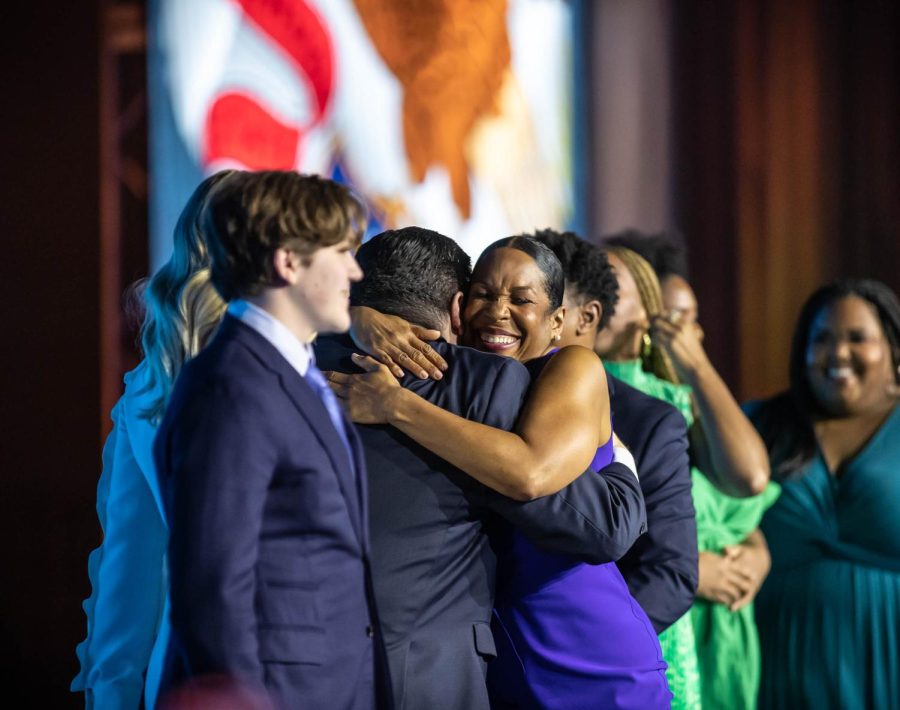 Family members of Pritzker and Stratton close the night embracing and celebrating on stage.