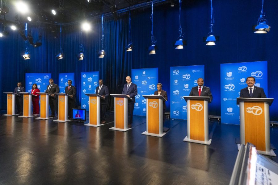 From left, Chicago mayoral candidates JaMal Green Sophia King, Kam Buckner, Willie Wilson, Brandon Johnson, Paul Vallas, current Mayor Lori Lightfoot, Roderick Sawyer and Jesús Chuy García get ready to debate one another at WLS-TV ABC Channel 7s studio, Thursday, Jan. 19, 2023, in Chicago. (Tyler Pasciak/Chicago Sun-Times via AP)