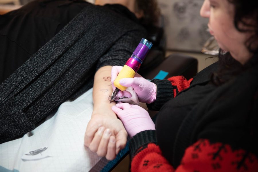 A detailed look into Dawn Graces tattoo of the day, a delicate peony is getting outlined and ready for coloring and shading, at Bella Rose Tattoo, located at 3811 N. Kedzie Ave. on Jan. 30. The tattoo gun buzzes loudly as it etches ink into the skin.