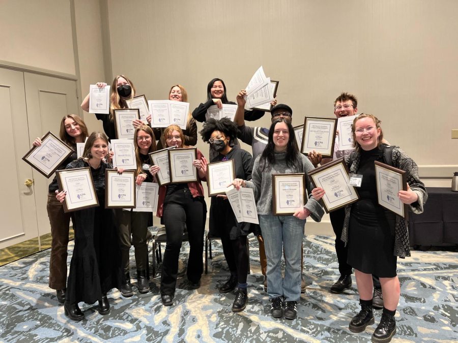 The Chronicle staff poses with many of the awards won at this years Illinois College Press Association. The publication took home 31 awards, from the conference which was held on February 17 and 18, 13 of which were first place. 