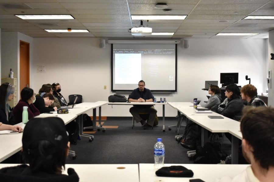 Austin St. Peter, the professor for one of Columbias science fiction classes, lectures the class located at at 33 E. Ida B. Wells Drive, on Friday Feb. 24. Some students still choose to wear their masks despite the mandate being lifted, while others no longer wear them.