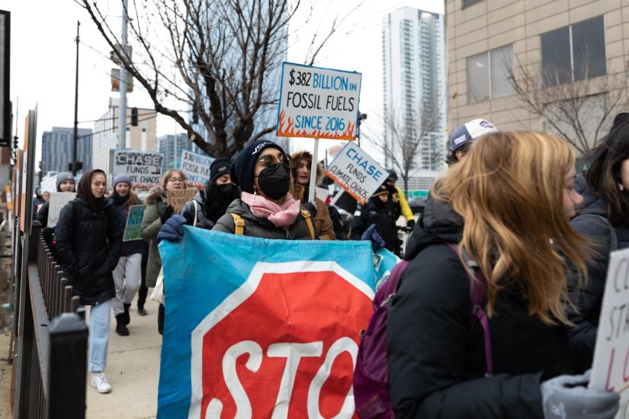 Protesters march towards Chase Tower, located at 10 S. Dearborn St. to spread awareness towards climate change on Friday, March 3. The crowd carried signs stating statistics and outrage towards Chase Bank.