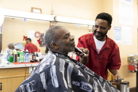 Samuel Brown puts finishing touches on his first client of the day, Darren Johnson, at a Haircuts For Humane event at Dannys Barber & Beauty Salon located at 241 W. 119th St. in Chicago on March 6, 2023. Johnson has been a long-time client of Browns and was eager to get a free haircut as he looks for re-employment.