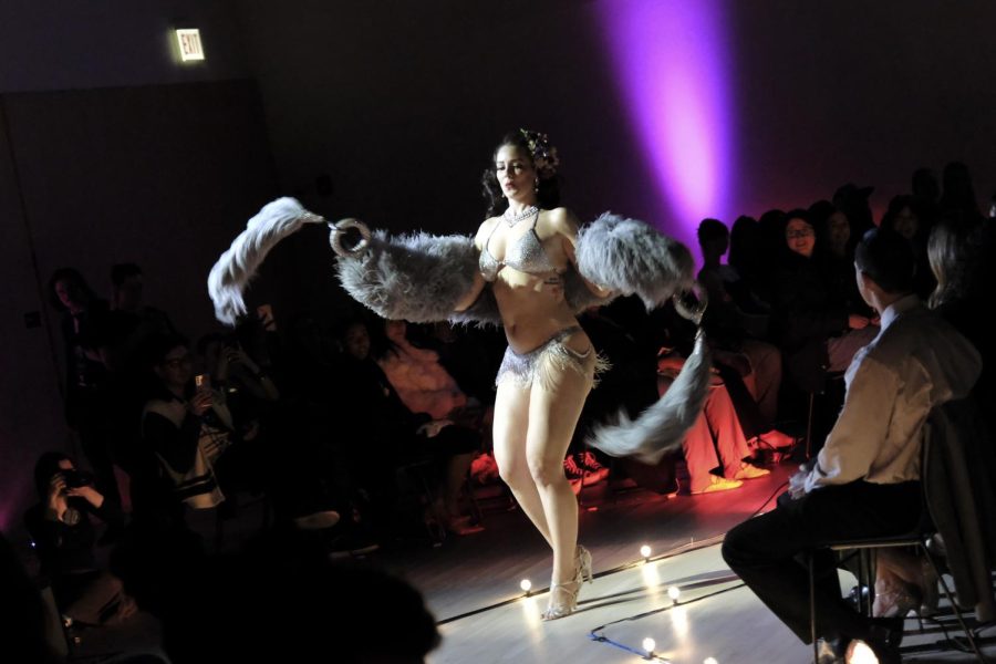 Ruby Spencer, a burlesque performer, twirls her fur scarf during her performance at the Student Center at 754 S. Wabash Ave., on Saturday, March 11. Spencer is the owner of Chicago School of Burlesque, an arts studio that provides dance and burlesque classes and workshops.